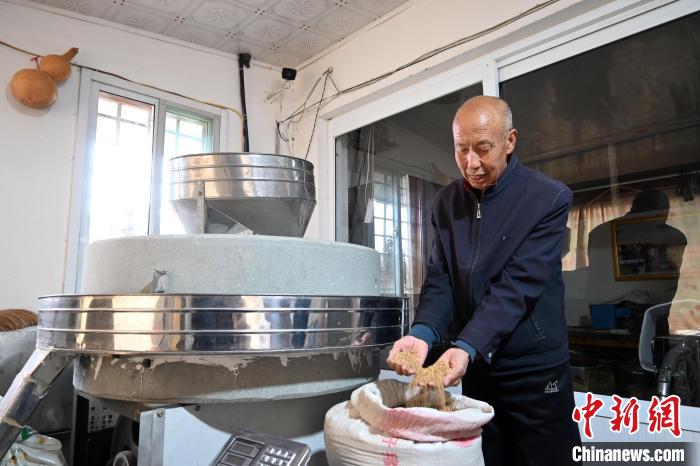 李家莊村民谷文朝重拾父輩的手藝，做起石磨面粉的營生?！〉杂鸺?攝