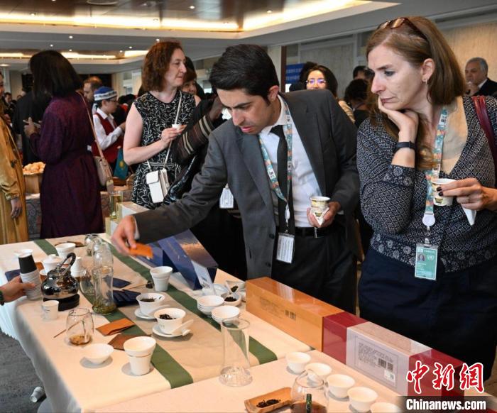 現(xiàn)場觀眾觀看中國展臺茶藝表演、了解茶文化。　靖樹 攝