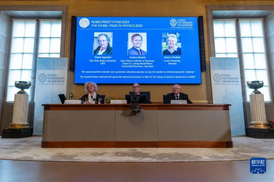 10月3日，在瑞典斯德哥爾摩舉行的2023年諾貝爾物理學(xué)獎公布現(xiàn)場，屏幕上顯示獎項得主皮埃爾·阿戈斯蒂尼（左）、費倫茨·克勞斯（中）和安妮·呂利耶的照片。新華社發(fā)（魏學(xué)超攝）