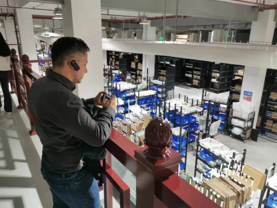 2023“一帶一路”媒體合作論壇聯(lián)合采訪團(tuán)團(tuán)員在仁和醫(yī)藥物流園拍攝記錄轉(zhuǎn)運(yùn)流程。（本報(bào)記者 黃超攝）