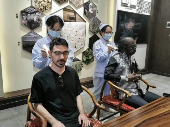 2023“一帶一路”媒體合作論壇聯(lián)合采訪團(tuán)團(tuán)員在九牛草展示館體驗(yàn)艾灸。（本報(bào)記者 黃超攝）