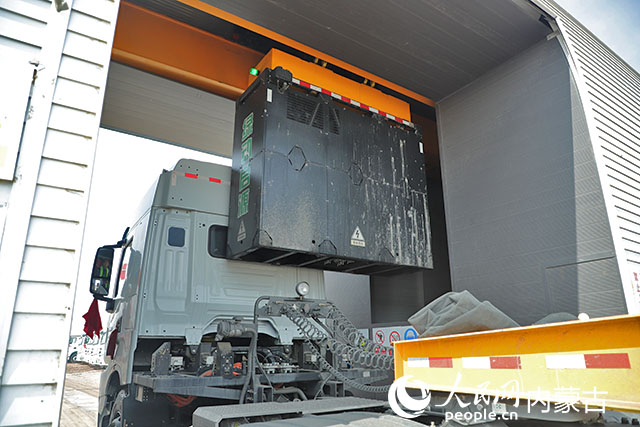 萬利新能源數(shù)字陸港里，正在充換電站進(jìn)行換電的重卡。人民網(wǎng)記者 趙夢(mèng)月攝