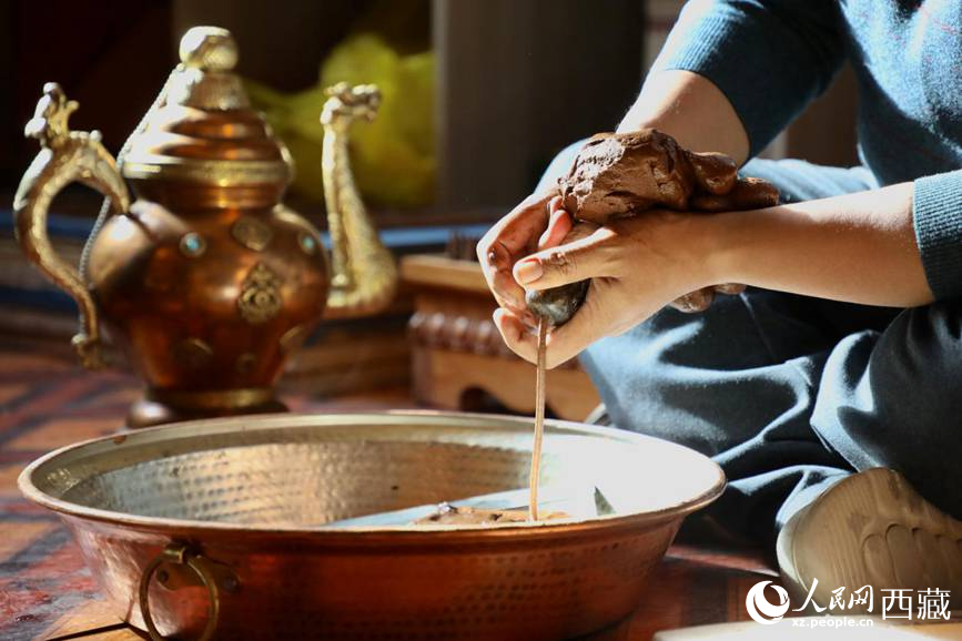 牛角鉆孔，將木泥擠出。人民網(wǎng)記者 次仁羅布攝