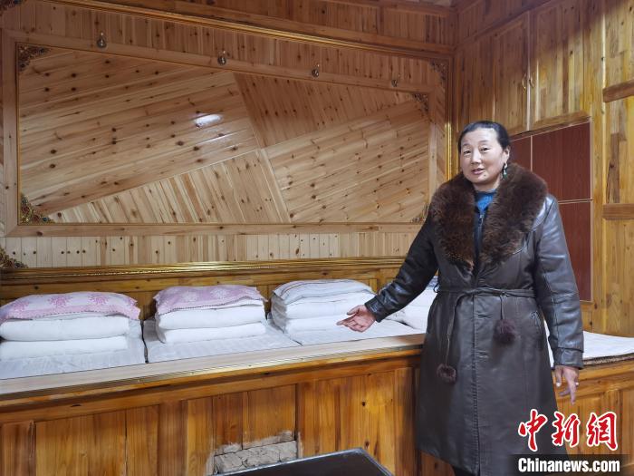 圖為德吉村村民鬧尖措介紹自家農(nóng)家樂?！∑钤鲚?攝