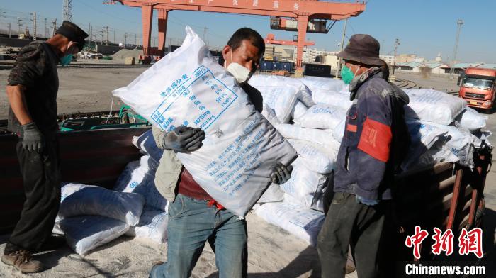 圖為裝卸人員將食鹽從汽車倒裝到火車上?！±钌?攝