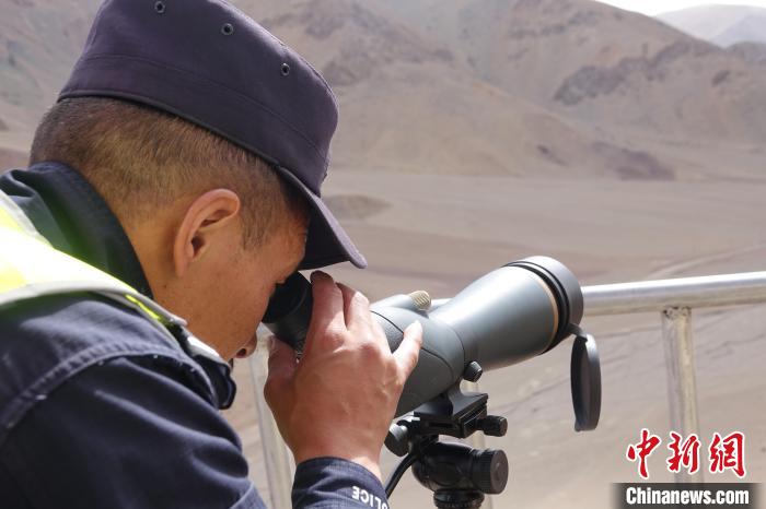 索朗曲扎用望遠鏡查看邊境情況。　冉文娟 攝