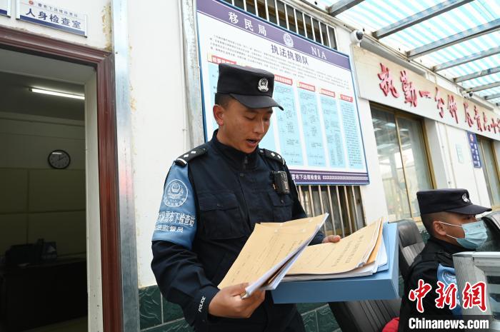 圖為洛桑朗嘎向記者展示卷宗?！≮w朗 攝