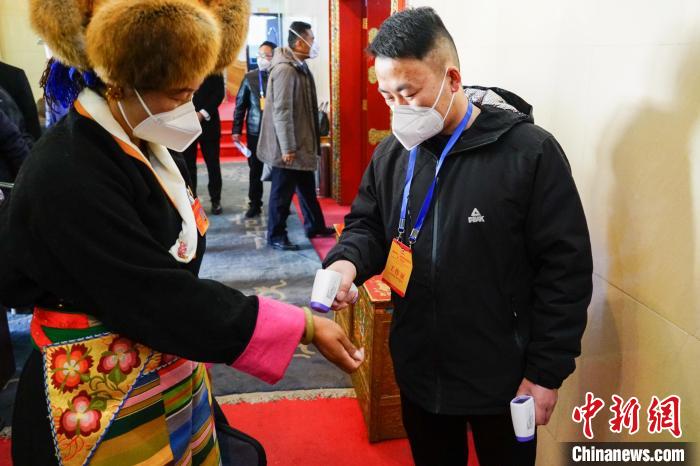 政協(xié)委員測(cè)體溫后入場(chǎng)?！〗w波 攝